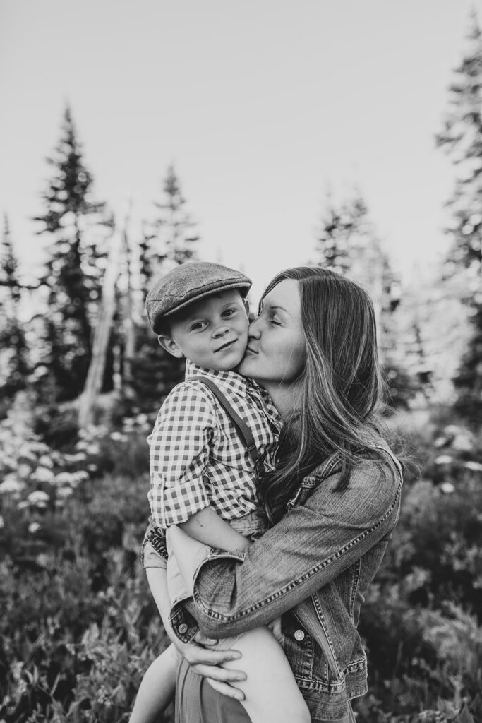 Mom kissing her toddler son on the cheek.