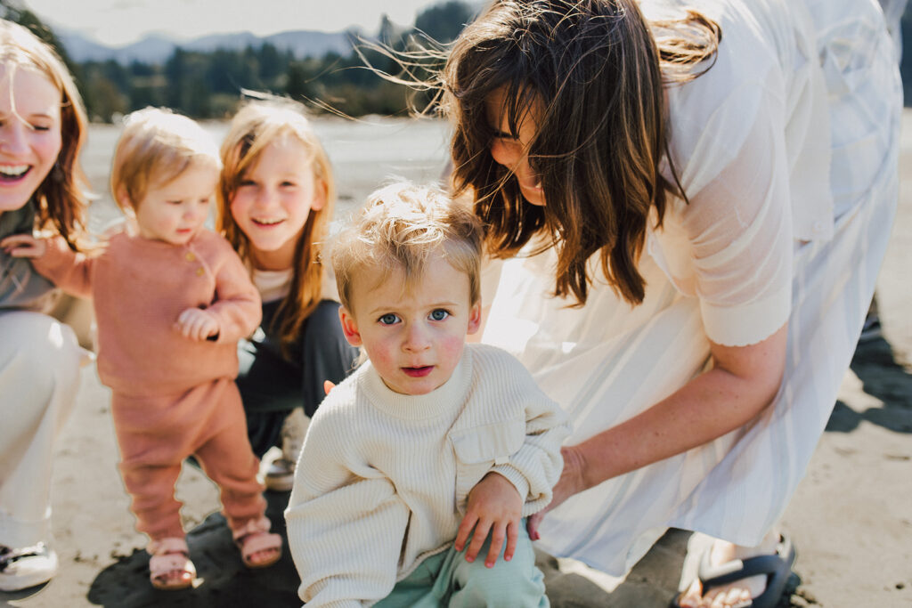 A mom and her children playing on the beach