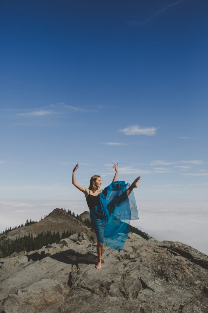 A girl dancing on a mountain top at Deer Park near Port Angeles