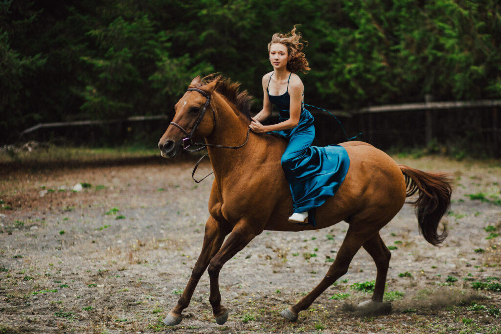 A girl riding bare back on her horse. 