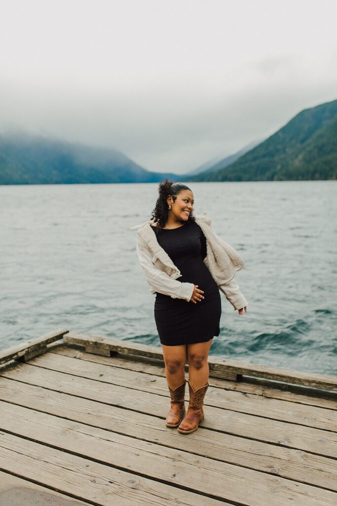 Girl smiling and dancing on the dock on Lake Crescent